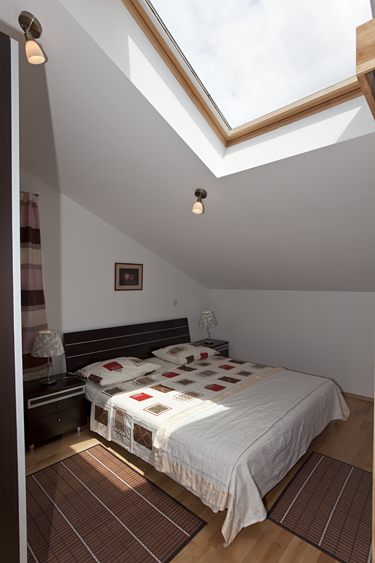 first bedroom with motorised sky panoramic window